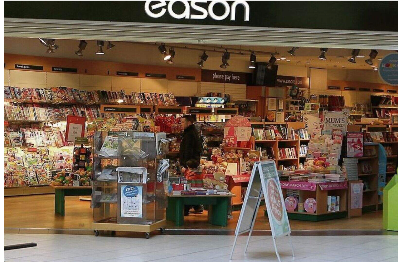 A large book and magazine retailer presenting books to browsing customers
