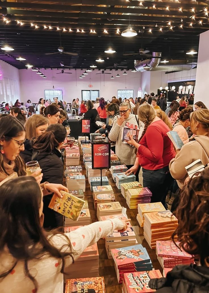 Readers browsing and buying books at a busy public book event