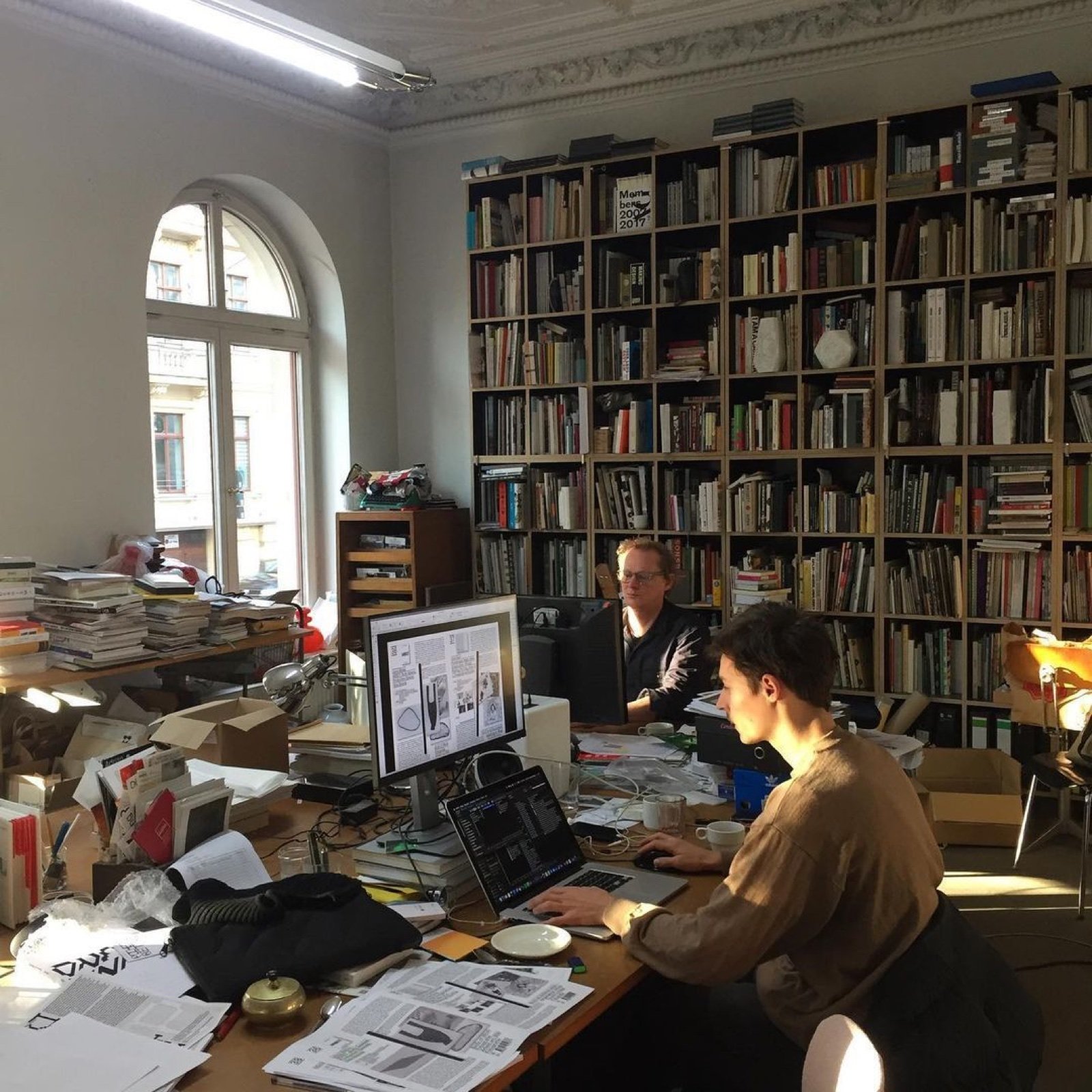 Publishing professionals refining book layouts and production files
